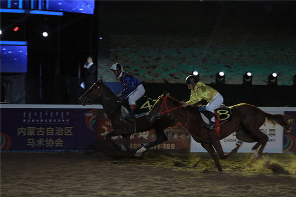 Jockeys compete during a nighttime horse racing event at the Fifth International Equestrian Festival in Hohhot, Inner Mongolia autonomous region on Sept 21.jpg