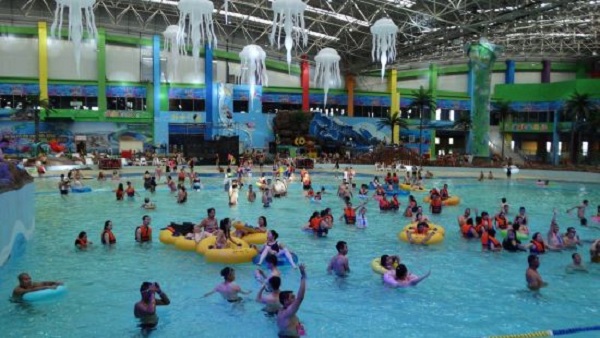 Parents play with their children in a large water playground of the water park.jpg