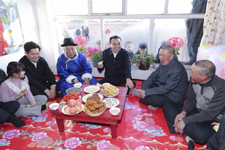 Premier Li calls for efforts to improve people's wellbeing