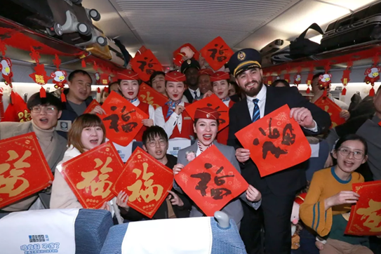Foreign crew members serve Spring Festival travelers on high-speed railway