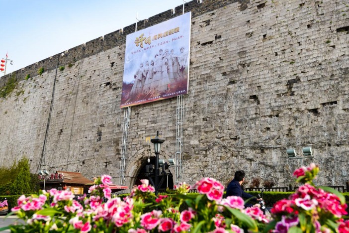 Nanjing displays heroes on posters above city gates for Qingming