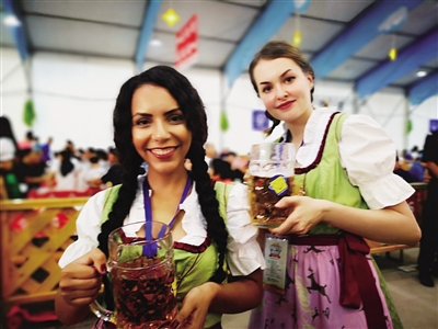 Two German waitresses pose for a photograph at the opening ceremony of Oktoberfest in Hohhot, Inner Mongolia autonomous region, July 7.jpg
