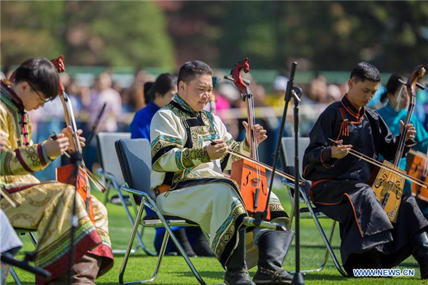 Students of Hohhot Minzu College play Matou fiddles at a Nadam fair of the school in Hohhot.jpg