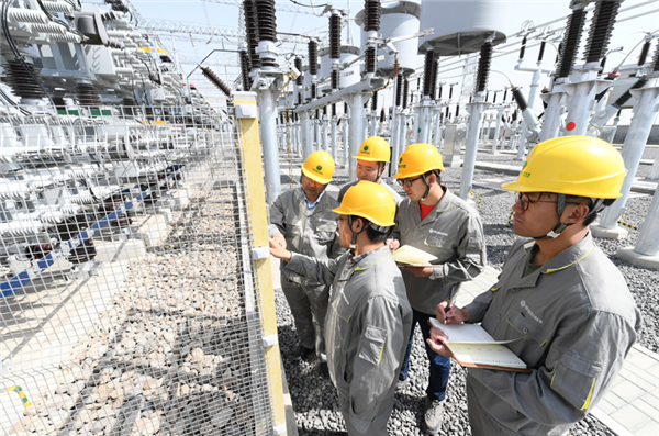 Workers check power equipment.png