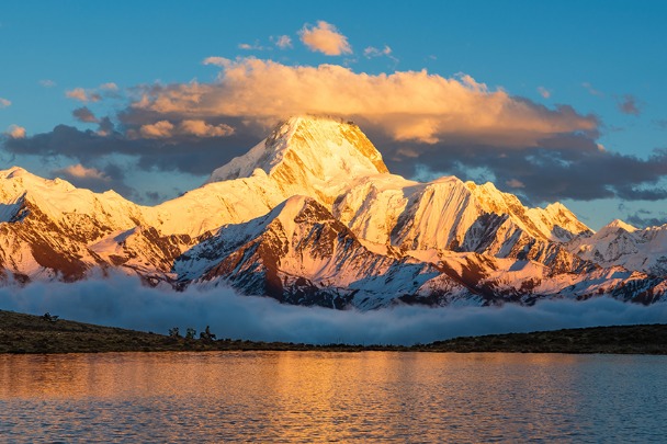 Snow-capped mountain resembles golden palace in the sun