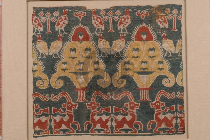 Centuries-old woven fabric with chicken, sheep and lamp patterns