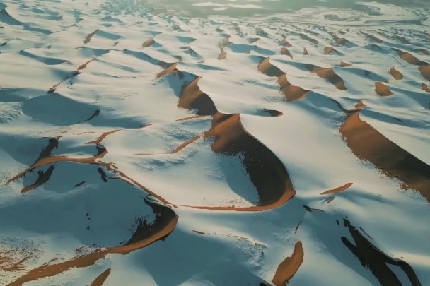 Breathtaking scenery of snow-covered Tengger Desert