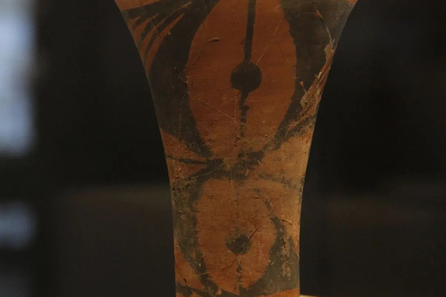 Prehistoric red pottery cup with black patterns