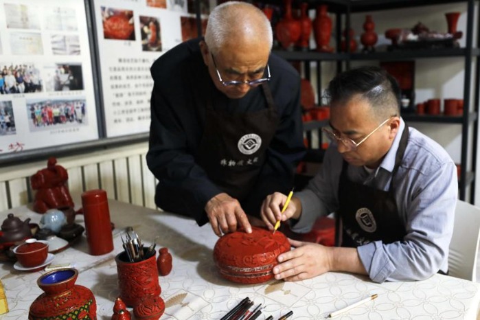 Master artisan hands skills to his son
