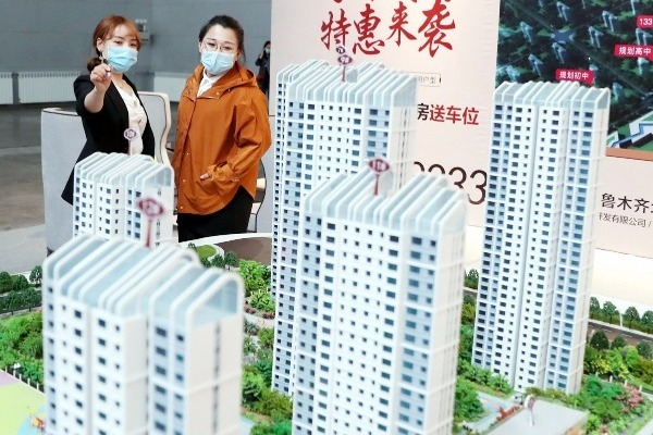 Key Chinese cities adjust buying regulations to boost real estate market