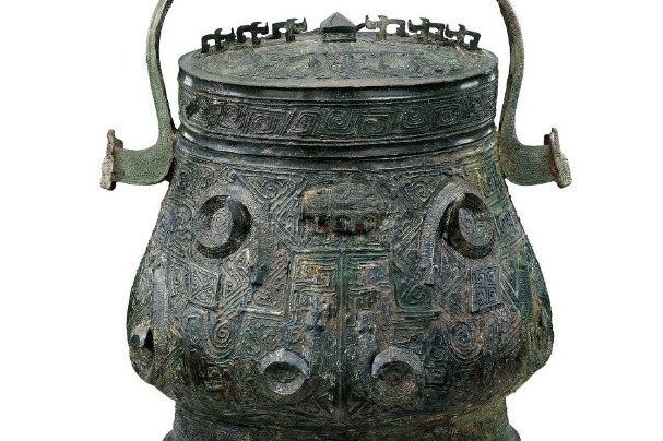 Ancient bronze vessel decorated with embossed snake motifs