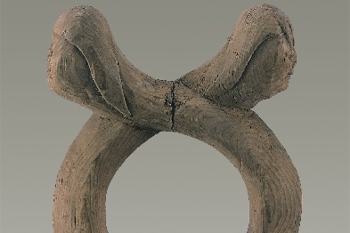 10th-century wooden sculpture depicts two heads sharing a snake body