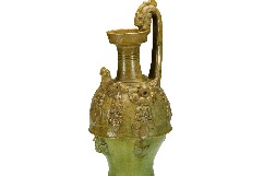 Yellow-green glazed ewer features delicate decorations